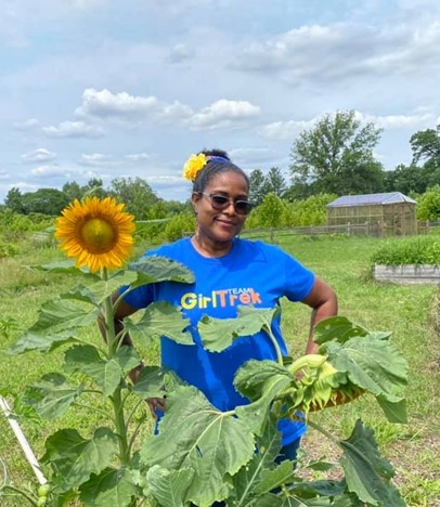 Angela Lugo-Thomas with sunflower